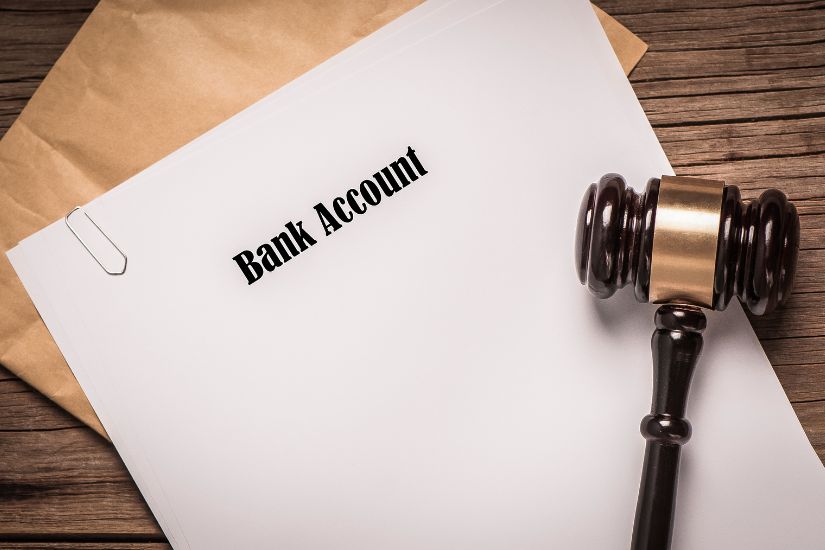 Consolidate your bank accounts to simplify your finances. A letter with bank account written on.