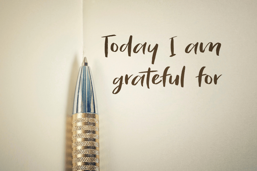 Gratitude practice, A book written with a pen and the beginning of a sentence: I am grateful for.
