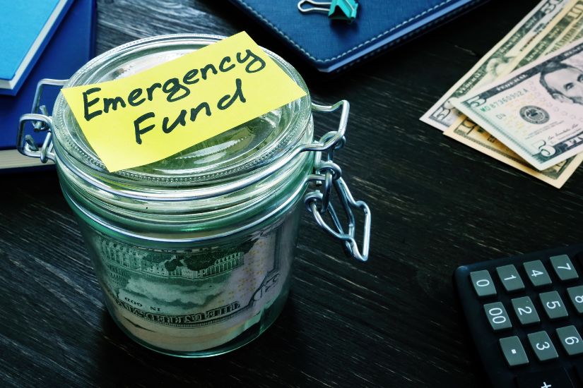 Have a budget for emergencies. A jar filled with savings for an emergency fund.