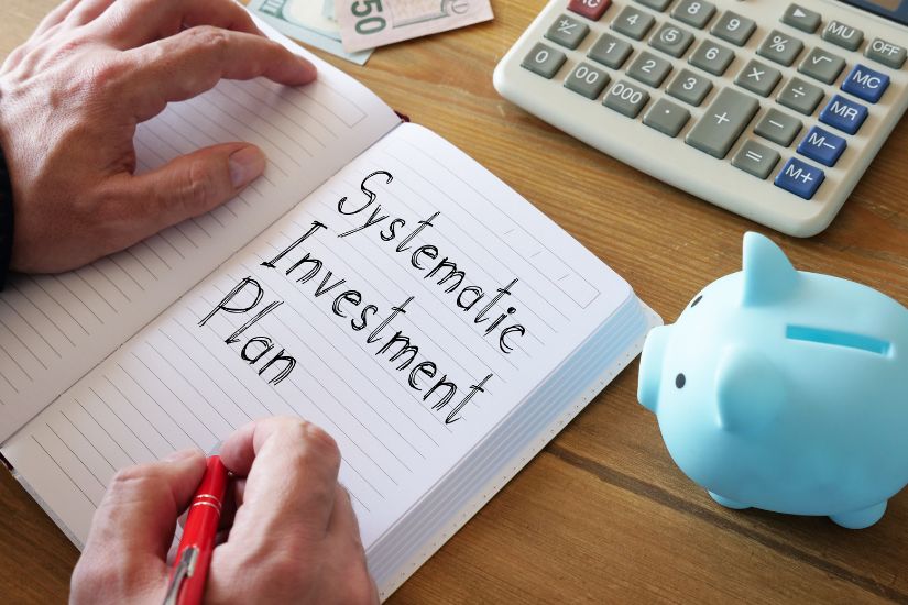 Set up your automatic investment savings plan today. A note book with the word "Systematic investment plan" written.