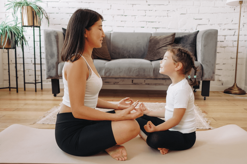 A mother and her daughter practice mindfulness and meditation during their daily morning routine.