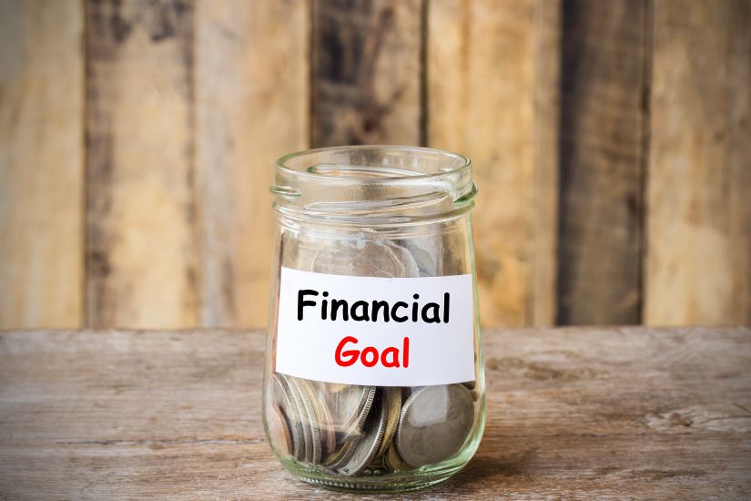 Set financial goals. A glas showing money for a financial goal.