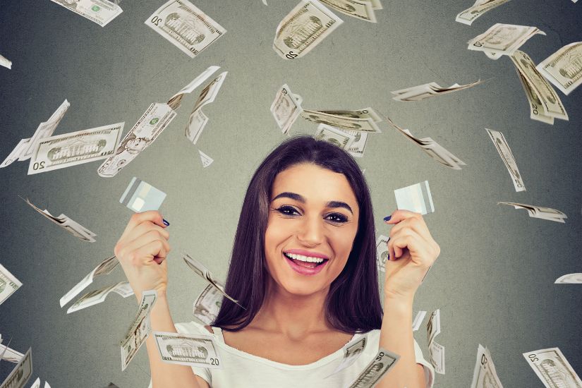 Creating a plan to reduce your debt is part of every personal finances, women. A woman throwing money and laughing.