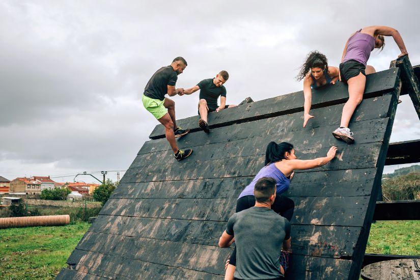 No matter how carefully you plan and how clear you are about what you want to do and the steps needed to get there, obstacles are inevitable. A group of people climbing a wall.