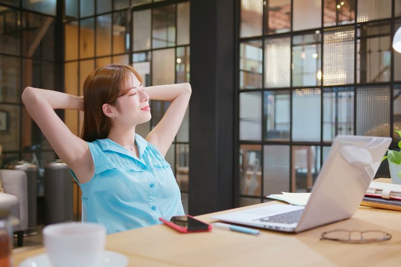 Whether it’s reading, watching a show, or a family activity, this time is crucial for maintaining a work-life balance. A woman relaxing.