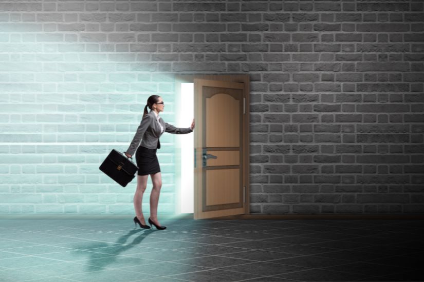 Stay ahead by anticipating and adapting to evolving market trends and opportunities. A woman opens a door.