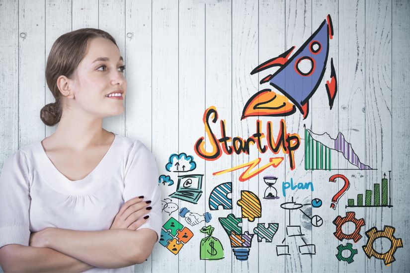 Building your online business starts with small steps, but eventually, you'll aim to generate real income and grow your revenue. A woman infront of a picture with Startup written.