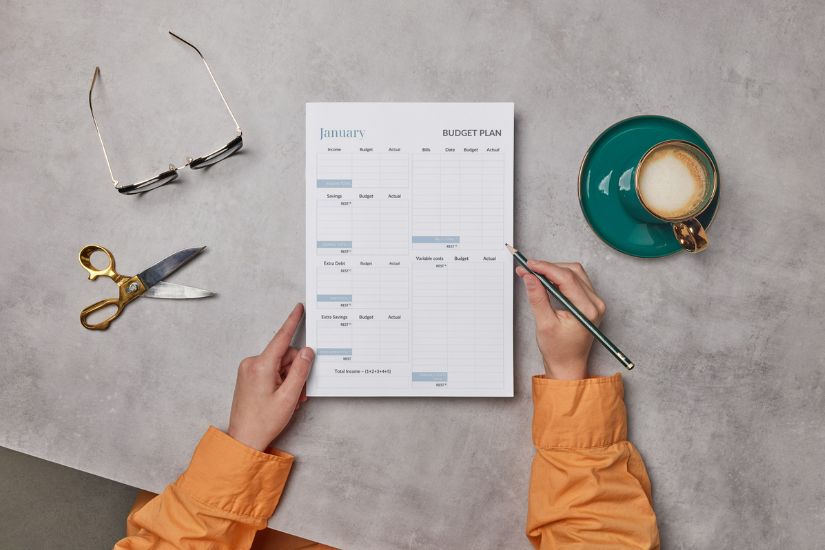 Creating a budget as a solopreneur is simpler than you might think. Here are the steps to get started.   Image of a solopreneur working on a budget