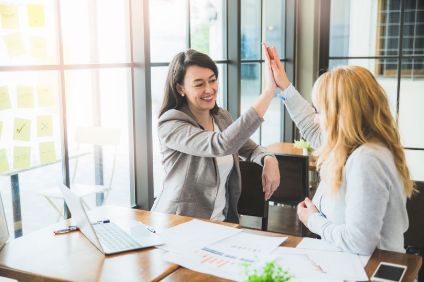 To effectively track your financial goals and stay on top of your financial life for the rest of the year, consider finding an accountability partner. Two women working on their finances.