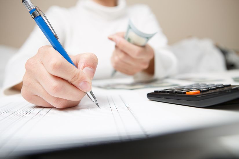 Regularly review your budget and track your progress to ensure you're still on course. Person reviewing financial plan