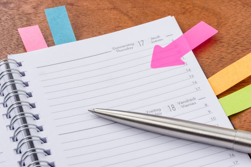 Optimization means finding ways to allocate more money toward your goals so you can reach them faster. A calendar or planner with budget review notes