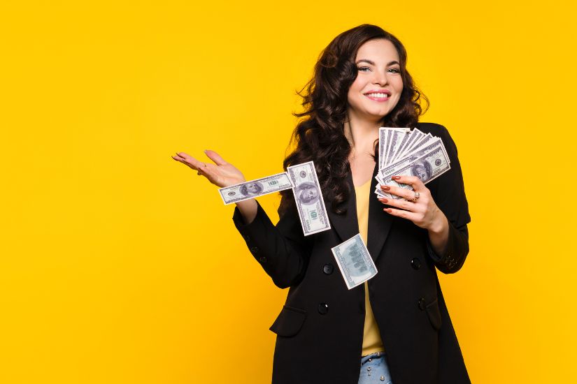 If you won $100,000 or more, what would you do with it? Could you hold onto it, or would you immediately spend it? A woman holding money in her hands